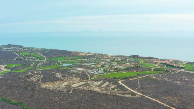 LA PLAYITA LOS CABOS MEXICO-2021: Clouds Drifting Over Rocky Terrain and Green Fields