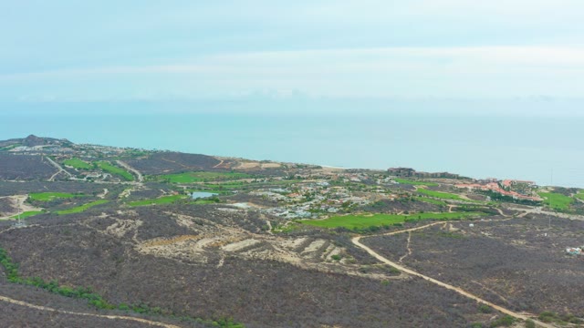 LA PLAYITA LOS CABOS MEXICO-2021: Coastal Hills with Winding Road and Moving Vehicle