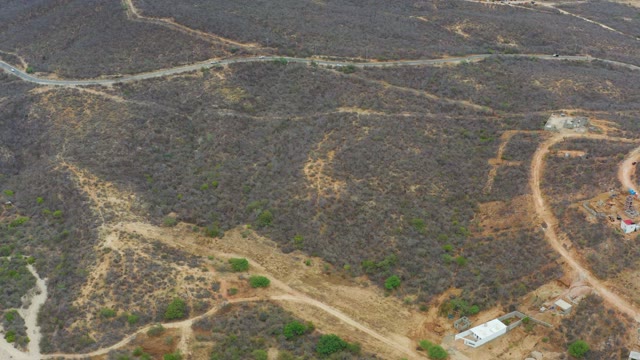 LA PLAYITA LOS CABOS MEXICO-2021: Dry Hillside with Dirt Roads and Moving Vehicle