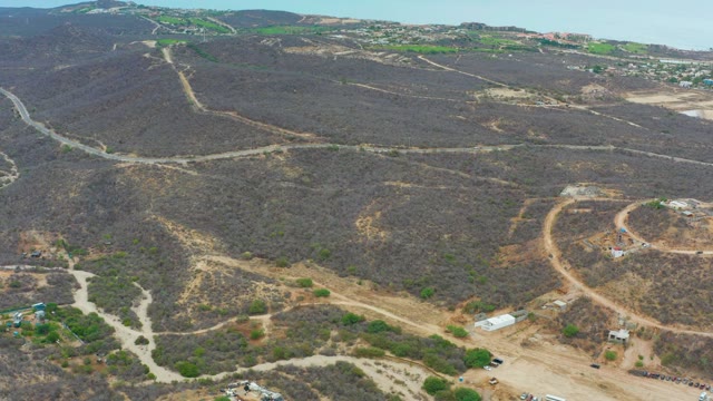 LA PLAYITA LOS CABOS MEXICO-2021: Hilly Terrain with Dirt Roads and Moving Vehicles