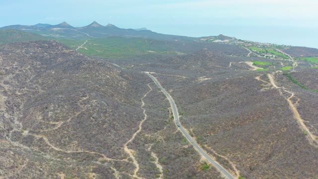 LA PLAYITA LOS CABOS MEXICO-2021: Car Traveling on Winding Mountain Road