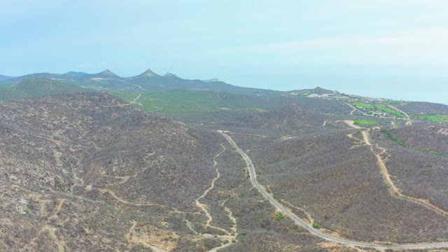 LA PLAYITA LOS CABOS MEXICO-2021: Aerial of Vehicle Moving Along Mountain Path