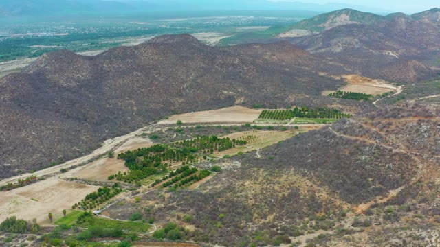 LA PLAYITA LOS CABOS MEXICO-2021: Pan of Mountain Valley with Agricultural Fields