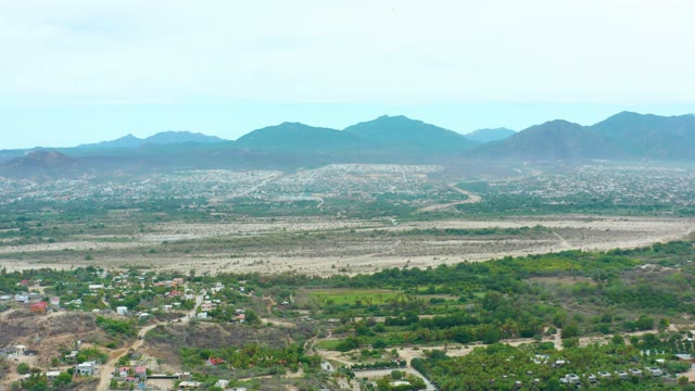 LA PLAYITA LOS CABOS MEXICO-2021: Valley with Distant Mountains and Scattered Settlements