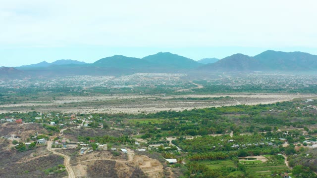 LA PLAYITA LOS CABOS MEXICO-2021: Mountain Valley with Scattered Settlements and Distant Peaks
