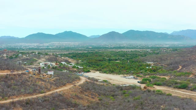 LA PLAYITA LOS CABOS MEXICO-2021: Hillside with Buildings and Parking Lot From Above