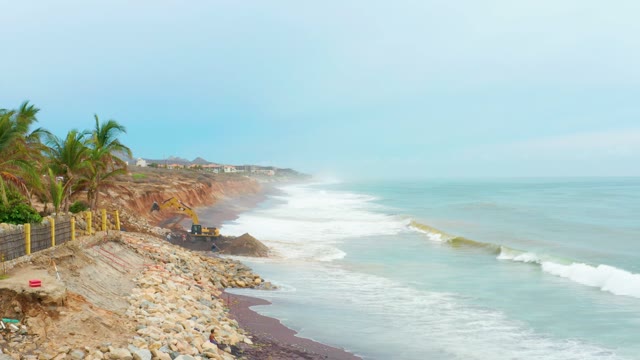 LA PLAYITA LOS CABOS MEXICO-2021: Waves Crashing on Rocky Shore with Construction Site