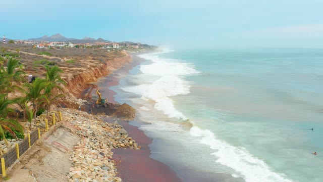 LA PLAYITA LOS CABOS MEXICO-2021: Excavator Working on Coastal Cliff Edge