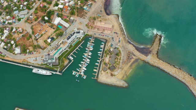 LA PLAYITA LOS CABOS MEXICO-2021: Waves Crashing Against Coastal Breakwater and Marina