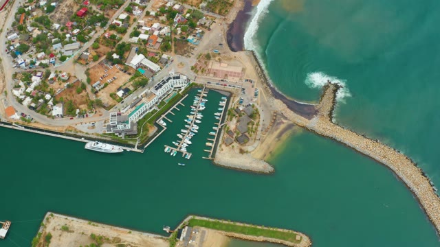 LA PLAYITA LOS CABOS MEXICO-2021: Ocean Waves Crashing Against Breakwater Near Marina