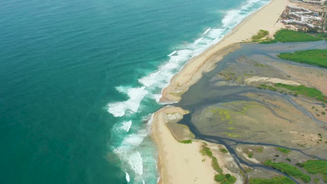 LA PLAYITA LOS CABOS MEXICO-2021: Ocean Waves Breaking on Sandy Shore Near Estuary