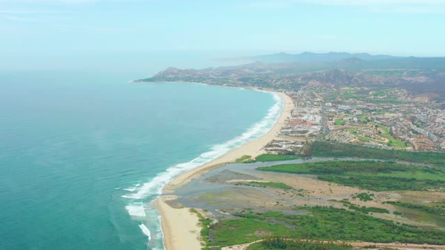 LA PLAYITA LOS CABOS MEXICO-2021: Ocean Waves Rolling Onto Sandy Coastline