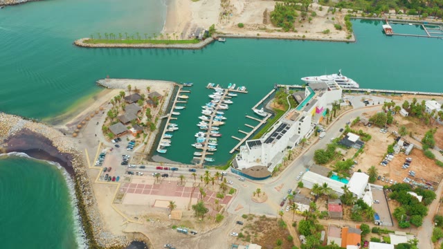 LA PLAYITA LOS CABOS MEXICO-2021: Waves Lapping Against Rocky Breakwater at Marina