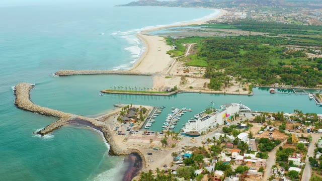 LA PLAYITA LOS CABOS MEXICO-2021: Waves Crashing Against Coastal Breakwater and Beach