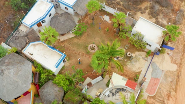 LA PLAYITA LOS CABOS MEXICO-2021: Courtyard with White Buildings and Palm Trees From Above