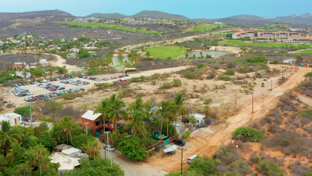 LA PLAYITA LOS CABOS MEXICO-2021: Desert Landscape with Parking Lot and Distant Hills