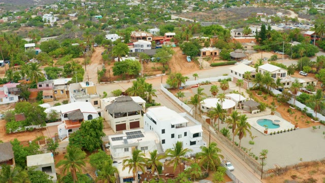 LA PLAYITA LOS CABOS MEXICO-2021: Residential Neighborhood with White Houses and Palm Trees