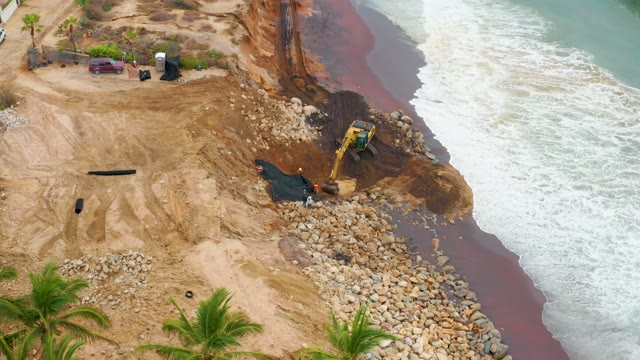 LA PLAYITA LOS CABOS MEXICO-2021: Excavator Placing Rocks for Coastal Erosion Control