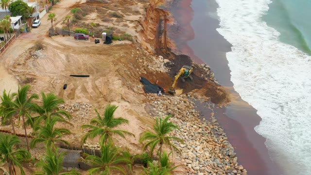 LA PLAYITA LOS CABOS MEXICO-2021: Coastal Construction with Excavator and Ocean Waves