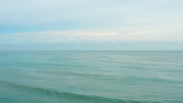 LA PLAYITA LOS CABOS MEXICO-2021: Gentle Ocean Waves Under Cloudy Sky