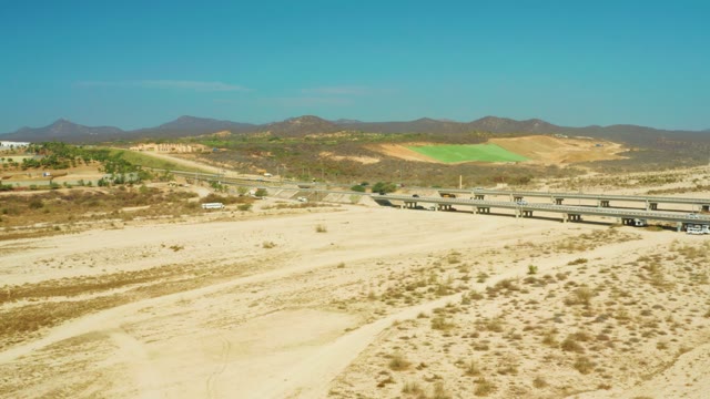 EL TULE BEACH LOS CABOS BCS MEXICO-2021: Vehicle Moving on Highway Overpass in Arid Landscape