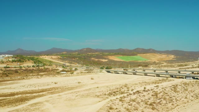 EL TULE BEACH LOS CABOS BCS MEXICO-2021: Aerial Desert Scene with Bridge and Moving Vehicles