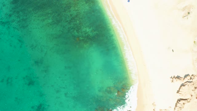 EL TULE BEACH LOS CABOS BCS MEXICO-2021: Turquoise Ocean Waves Lapping Sandy Shore