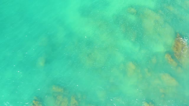 EL TULE BEACH LOS CABOS BCS MEXICO-2021: Overhead View of Turquoise Water with Underwater Rocks