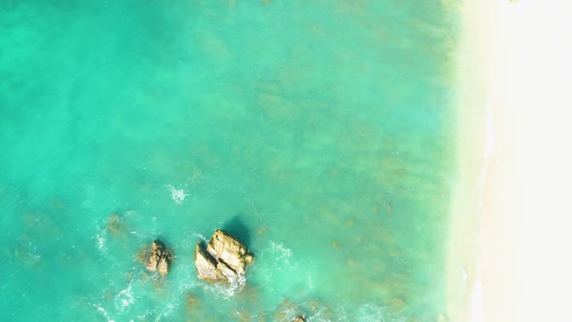 EL TULE BEACH LOS CABOS BCS MEXICO-2021: Rocks in Shallow Turquoise Ocean Water Near Beach