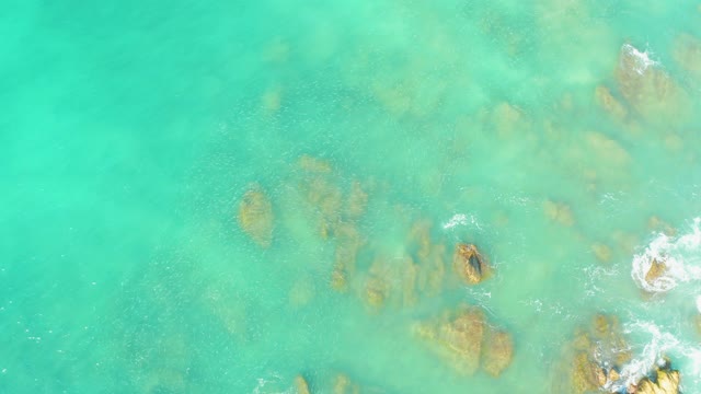 EL TULE BEACH LOS CABOS BCS MEXICO-2021: Turquoise Ocean Water Lapping Over Submerged Rocks