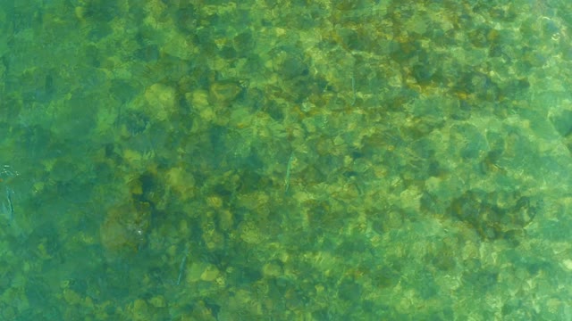 EL TULE BEACH LOS CABOS BCS MEXICO-2021: Overhead View of Clear Ocean Water with Rocky Seabed