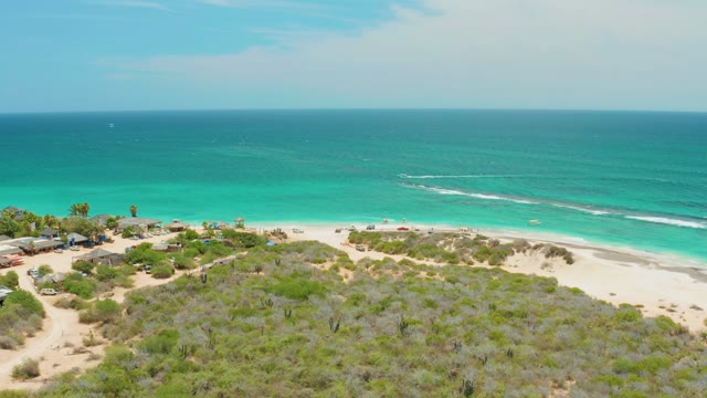 CABO PULMO LOS CABOS BCS MEXICO-2021: Beach Scene with Moving Car and Advancing Ocean Waves