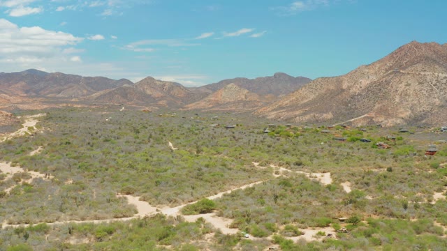 CABO PULMO LOS CABOS BCS MEXICO-2021: Desert Terrain with Mountain Backdrop and Winding Dirt Paths