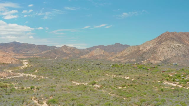 CABO PULMO LOS CABOS BCS MEXICO-2021: Vehicle Traveling on Desert Dirt Roads with Mountain Backdrop