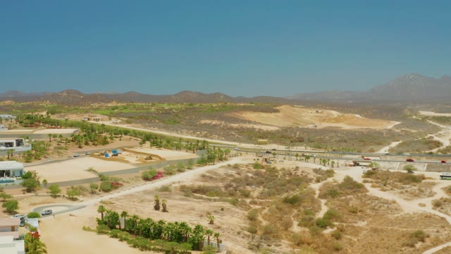 EL TULE BEACH LOS CABOS BCS MEXICO-2021: Desert Road with Moving Vehicles and Distant Mountains