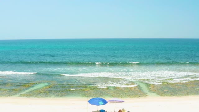 EL TULE BEACH LOS CABOS BCS MEXICO-2021: People Relaxing Under Umbrellas on a Sandy Beach