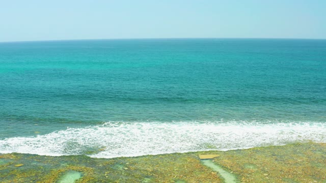 EL TULE BEACH LOS CABOS BCS MEXICO-2021: Waves Crashing on Rocky Shore with Turquoise Water