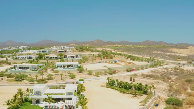 EL TULE BEACH LOS CABOS BCS MEXICO-2021: Vehicles Moving Along Desert Road with Modern Architecture