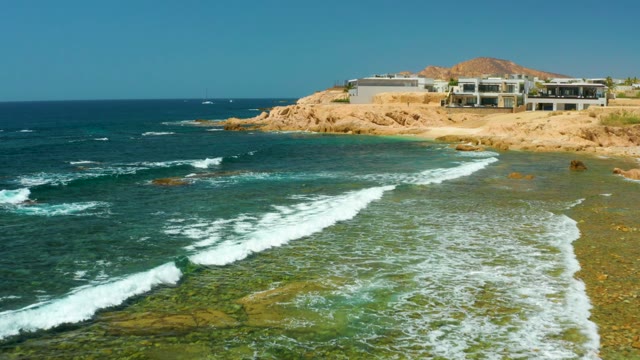 EL TULE BEACH LOS CABOS BCS MEXICO-2021: Waves Rolling Onto Rocky Shore with Clear Water