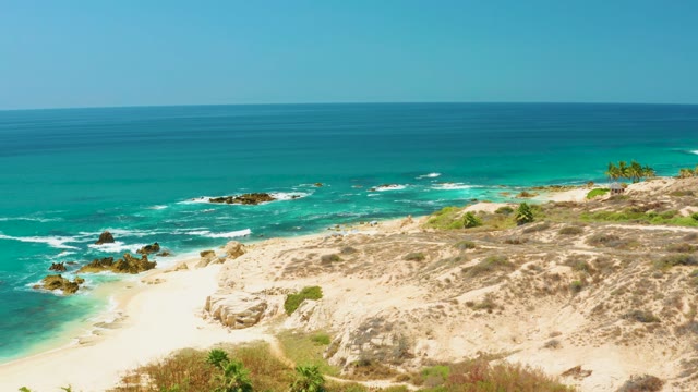 DREAMS LOS CABOS BCS MEXICO-2021: Waves Breaking on Sandy Shore with Rocky Outcrops