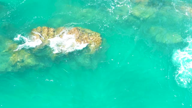 DREAMS LOS CABOS BCS MEXICO-2021: Waves Crashing on Submerged Rocks in Turquoise Water