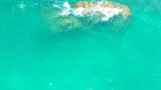 DREAMS LOS CABOS BCS MEXICO-2021: Waves Crashing Against Submerged Rocky Outcrop in Turquoise Water