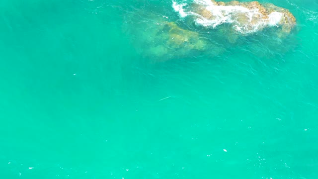 DREAMS LOS CABOS BCS MEXICO-2021: Waves Crashing Against Rocky Shore in Turquoise Water