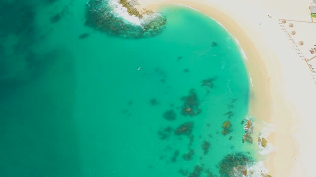 DREAMS LOS CABOS BCS MEXICO-2021: Swimmer in Clear Turquoise Water Near Sandy Shore