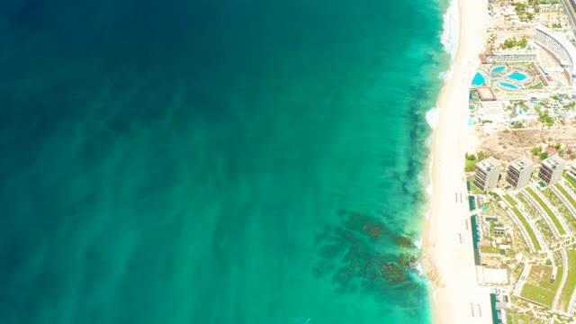 DREAMS LOS CABOS BCS MEXICO-2021: Gentle Ocean Waves Along White Sandy Beach with Resort