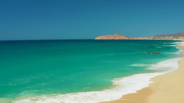 DREAMS LOS CABOS BCS MEXICO-2021: Waves Crashing on Sandy Beach with Turquoise Water