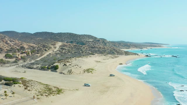SAN LUIS BEACH EAST CAPE LOS CABOS MEXICO-2021: Vehicles Traveling on Sandy Beach Road by Ocean