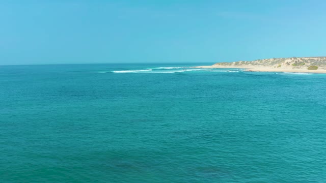 SAN LUIS BEACH EAST CAPE LOS CABOS MEXICO-2021: Gentle Ocean Waves Approaching Sandy Shoreline