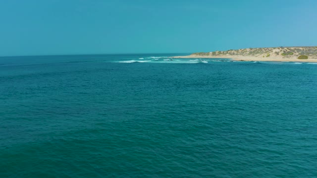 SAN LUIS BEACH EAST CAPE LOS CABOS MEXICO-2021: Gentle Ocean Waves Approaching Sandy Shoreline
