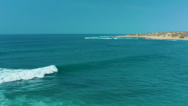 SAN LUIS BEACH EAST CAPE LOS CABOS MEXICO-2021: Ocean Waves Crashing and Receding on a Sandy Shore